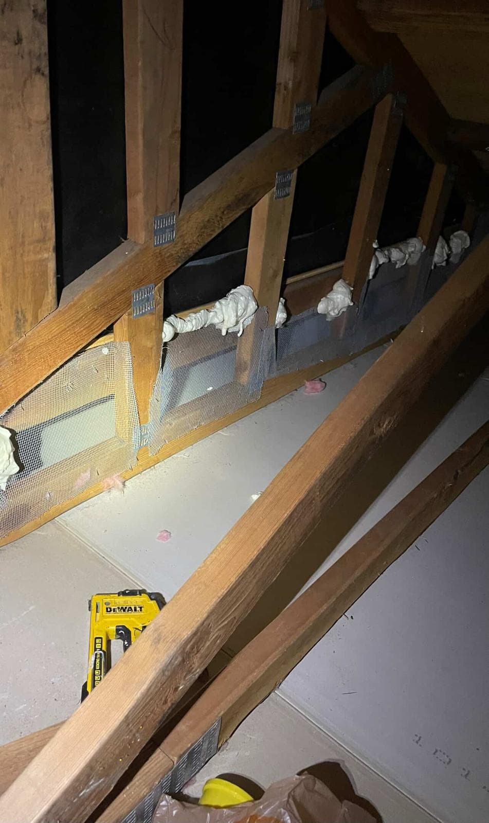 Stacked washer and dryer installation inside framed utility space